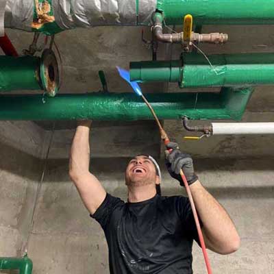 Brandon of LTD Plumbing & Mechanical laughing while working